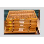 Nine brass handled sectional trays containing a large quantity of lead type in various founts