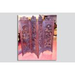 An excellent 20th Century hardwood four fold dressing screen having profusely pierced carved leaf