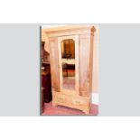 An Edwardian pine mirrored single door wardrobe with drawer below, 78.5 x 44 ins (199.5 x 112 cms)