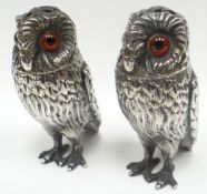 A pair of novelty silver salts and peppers in the form of standing owls, with glass eyes and