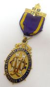 A 9ct yellow gold enamelled Oddfellows medallion with ribbon, inscribed presentation to the reverse,