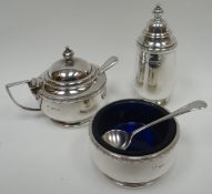 A silver three piece  condiment-set of circular-based plain form and with Bristol-blue glass liner