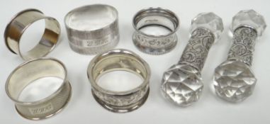 Five various silver napkin rings, 2.4ozs; together with a pair of hobnail cut-glass and foliate