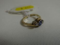 A 9ct yellow gold two-diamond and Ceylon sapphire cross-over ring, 2.2gms (with receipt for 1990