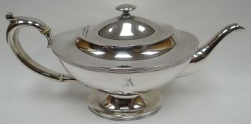 An oval-based silver tea-pot, with fixed-silver button knop to the hinged lid, ivory conductors,