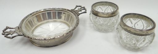 A Britannia silver twin-handled glass lined relish dish having a patterned rim and ornate open-