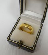 A 22ct yellow gold wedding-band, 8.9gms
