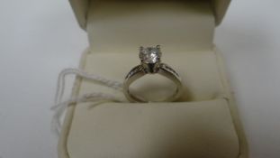 A 14k white gold ring with modern-round cut diamond in American four-claw setting and with small