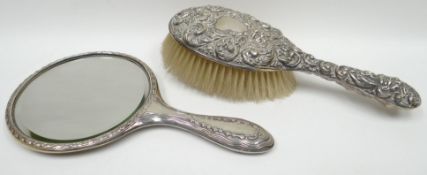 An Art Nouveau silver backed dressing-table mirror and non-matching brush