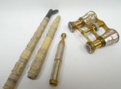 A set of Asprey's mother-of-pearl and gilt-metal opera-glasses with telescopic arm (disconnected);