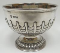 A circular-based silver bowl with gadrooned foot and raised fish-scale decoration to the body,