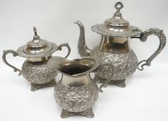 A Continental three piece tea service marked 'SILVER', highly embossed with floral decoration and