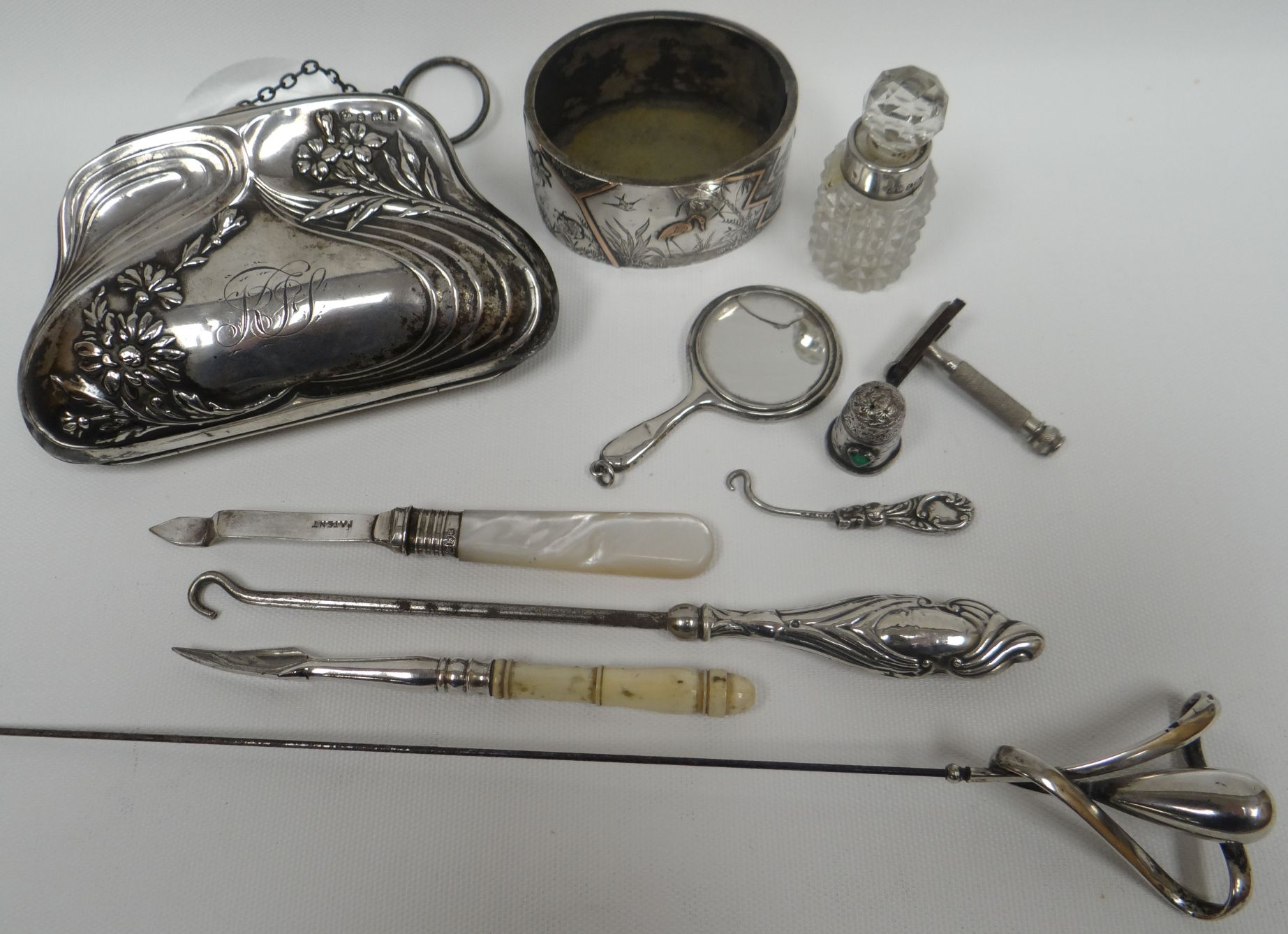 A parcel of silver / part-silver ladies etui including an Art Nouveau silver purse with leather