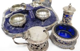 A three-piece pierced silver condiment-set with Bristol-blue glass liners, Birmingham 1899; together