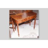 A Victorian mahogany foldover top tea table, the swivel top with bull nose edging above a frieze
