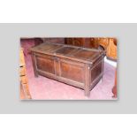 A late 18th/early 19th Century oak dower chest, the triple panelled top with bull nose edging over a