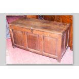 An antique oak loose lid dower chest, twin plank oak top with bull nose edge, double panelled