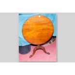 A Georgian mahogany circular tilt top table on turned column and splayed triple support, 30 ins (