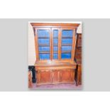 A Victorian oak and mahogany 2.5 door bookcase sideboard, a shaped top over twin arch glazed doors