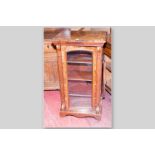 A Victorian walnut single glazed door music cabinet with box wood and ebony stringing, crossbanded