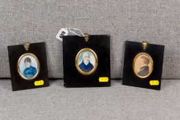 A group of three 19th Century portrait miniatures in black papier mache frames, all oval shaped