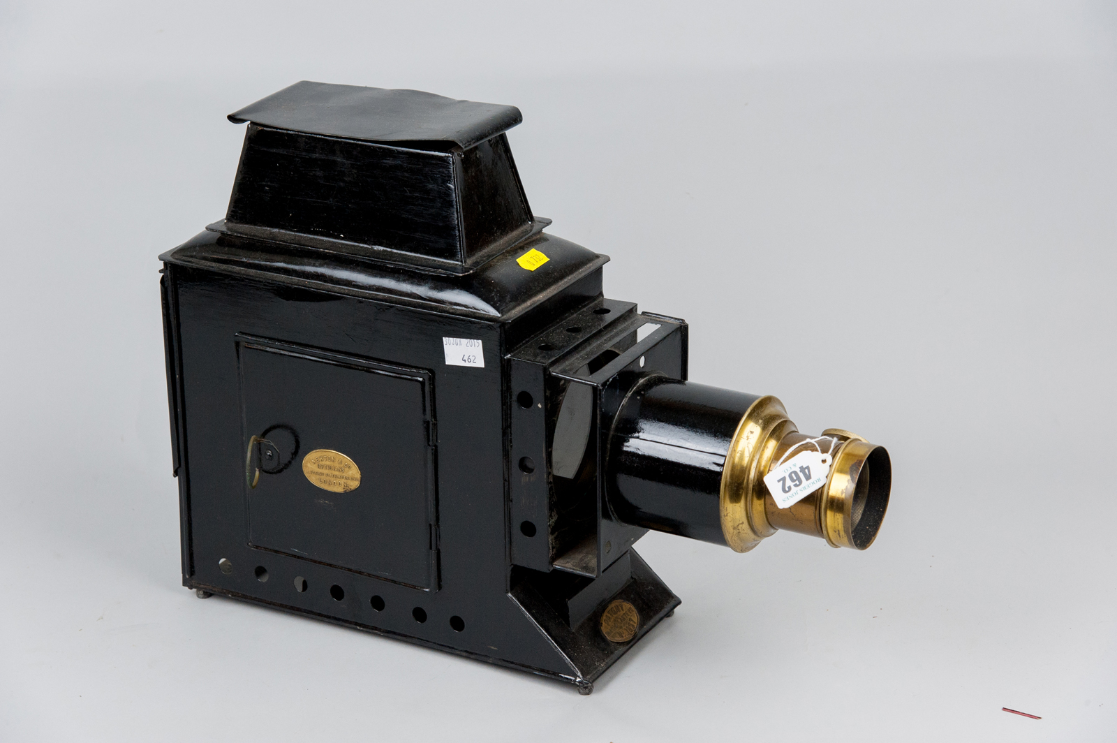 A black japanned Magic Lantern with brass fittings, patent no. 1857 and retailed by Newton & Co