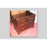 A Victorian two over two drawer chest with brass backplates and swing handles, standing on bracket