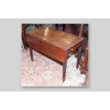 A Regency mahogany Pembroke twin flap table with single side drawer with turned knobs on reeded