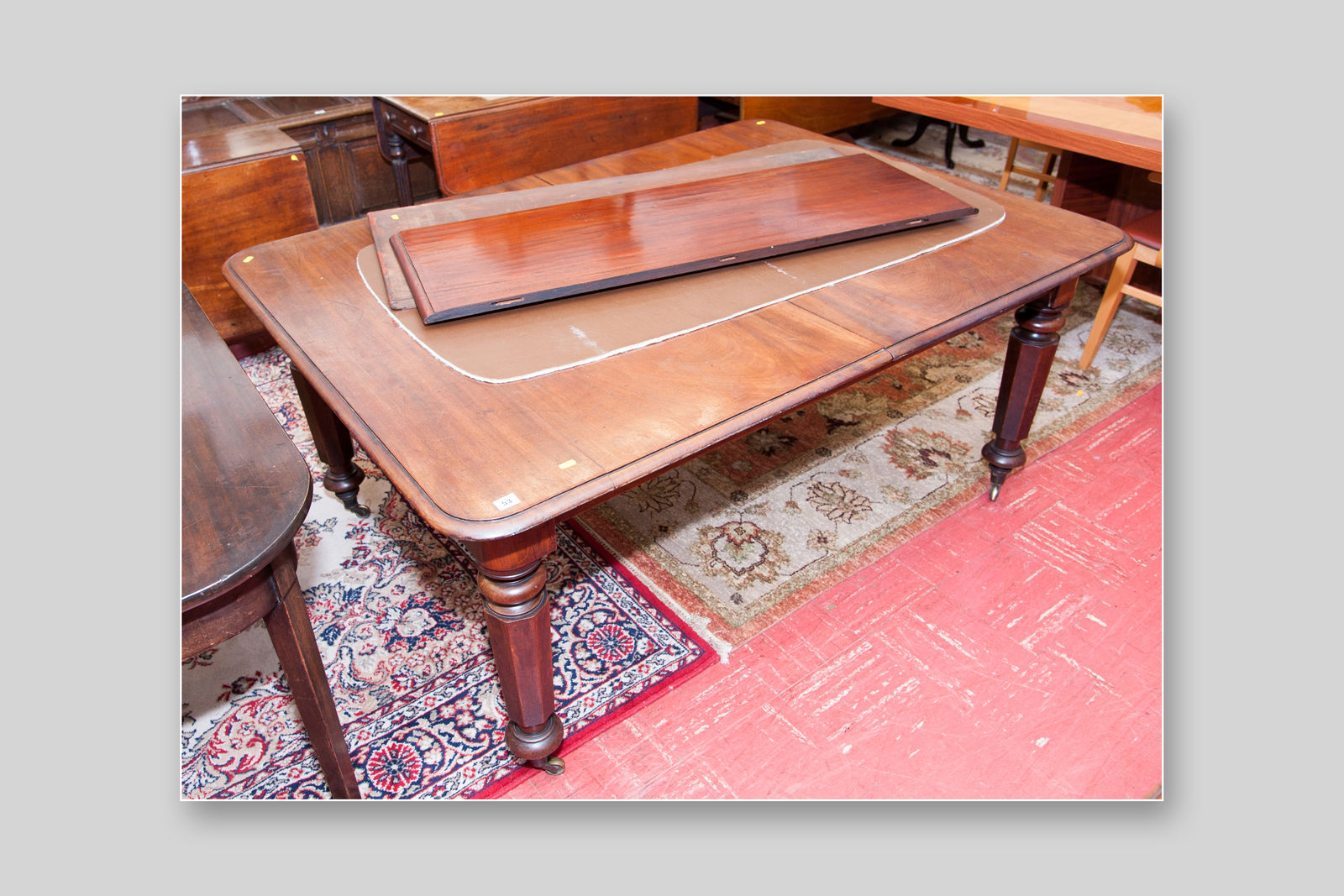 A Victorian mahogany pull-out extending table with two extra leaves, moulded edge round cornered
