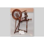 A 19th Century wooden Saxony spinning wheel with bone finial tips, 35 x 30 ins (89 x 76 cms), (