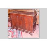 A Georgian pine lidded dower chest with triple panel front, twin panel sides on raised bracket feet,