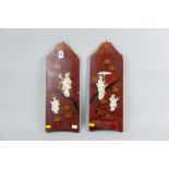 A pair of Japanese hanging red lacquer work panels, floral decorated with gilt highlighting, both
