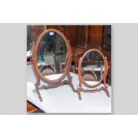 An Edwardian mahogany and line inlaid oval swing toilet mirror on shaped frame and raised supports