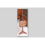 A Victorian mahogany polescreen with shaped adjustable face panel of fruit decorated velvet cloth,