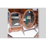 A Regency mahogany oval swing toilet mirror, 26 x 18 ins (66 x 45.5 cms) and a Victorian mahogany