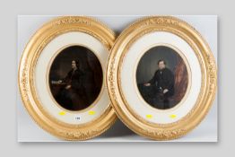 A pair of oval gilt framed Victorian tinted photographic portraits, each of a lady and a gentleman