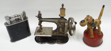A German-made painted metal miniature sewing machine, circa 1890; together with a Triang-Wakouwa