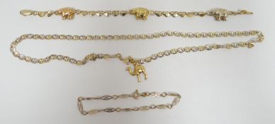 A believed 18ct yellow gold elephant-train bracelet, a 14ct yellow gold necklace with camel charm,