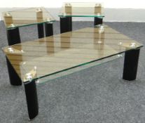 A suite of three contemporary glass topped tables, comprising lower long-john coffee table and two
