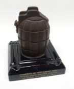 A First World War hand grenade mounted ash-tray inscribed 'MEMENTO OF THE GREAT WAR ACTUAL HAND