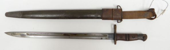 A British military 1917 Remington bayonet and scabbard with wooden handle and leather belt-