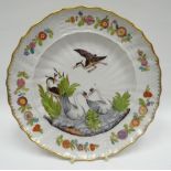 An early nineteenth century Continental painted and gilded porcelain plate having a moulded floral