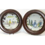 A pair of polychrome delft plates, painted in the Chinese taste with a figure each in landscapes,