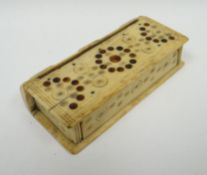 A primitive bone-made snuff box with inlay and sgraffito decoration to the body and the hinged