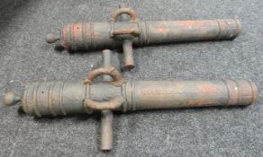 A pair of cast iron decorative cannons, believed Indian Colonial, with raised lettering to the