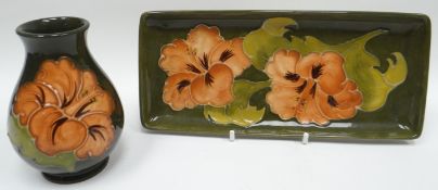 A Moorcroft green ground tube-lined rectangular dish, 8ins long (20cms) and matching squat vase