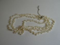 A three-strand necklet of freshwater-pearls