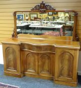 An Empire-style Victorian mahogany mirror-back sideboard having an inverted break-front base with