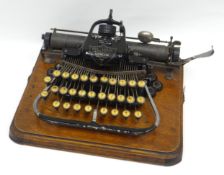 An early typewriter - the 'Blick No.7', circa 1898-1906, on wooden stand with wooden carry-cover