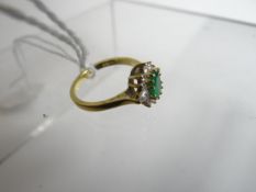 An 18ct yellow gold diamond and emerald cluster ring, 2.98gms
